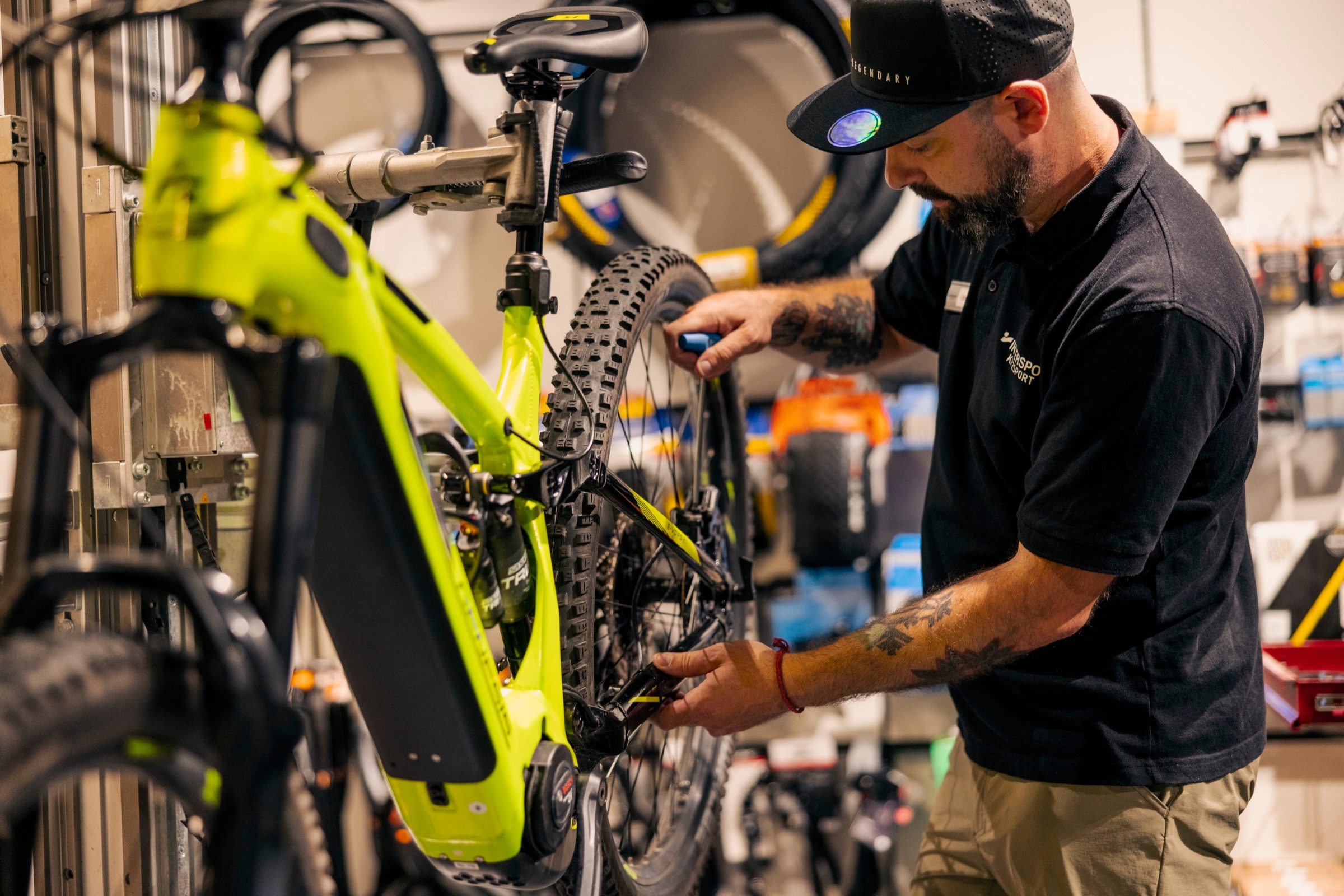 Ein Mechaniker prüft in der Werkstatt das Schaltwerk eines E-Mountainbikes